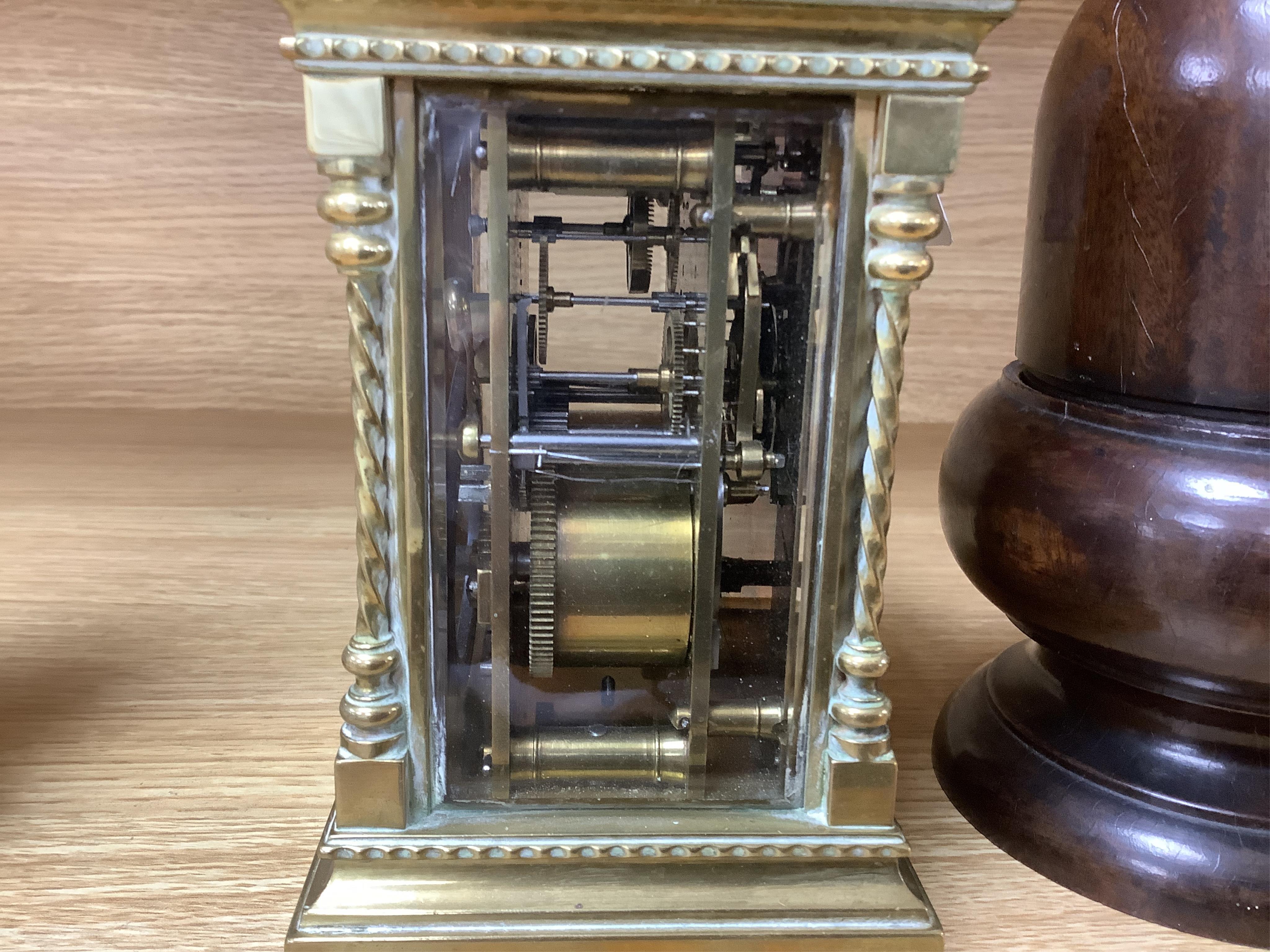 A large brass repeating carriage clock with key and ornate filigree dial, 17cm high (including handle). Condition - good, unchecked if working